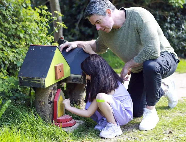 family next to a fairy house