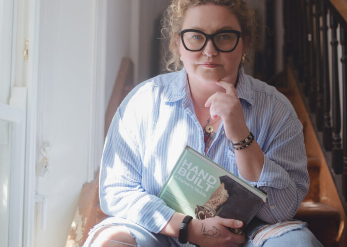 Ola sitting on stairs outside kitchen studio