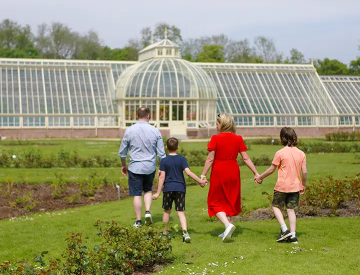 Family visiting the Glasshouse in the gardens